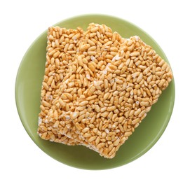 Photo of Plate with puffed rice bars (kozinaki) on white background, top view