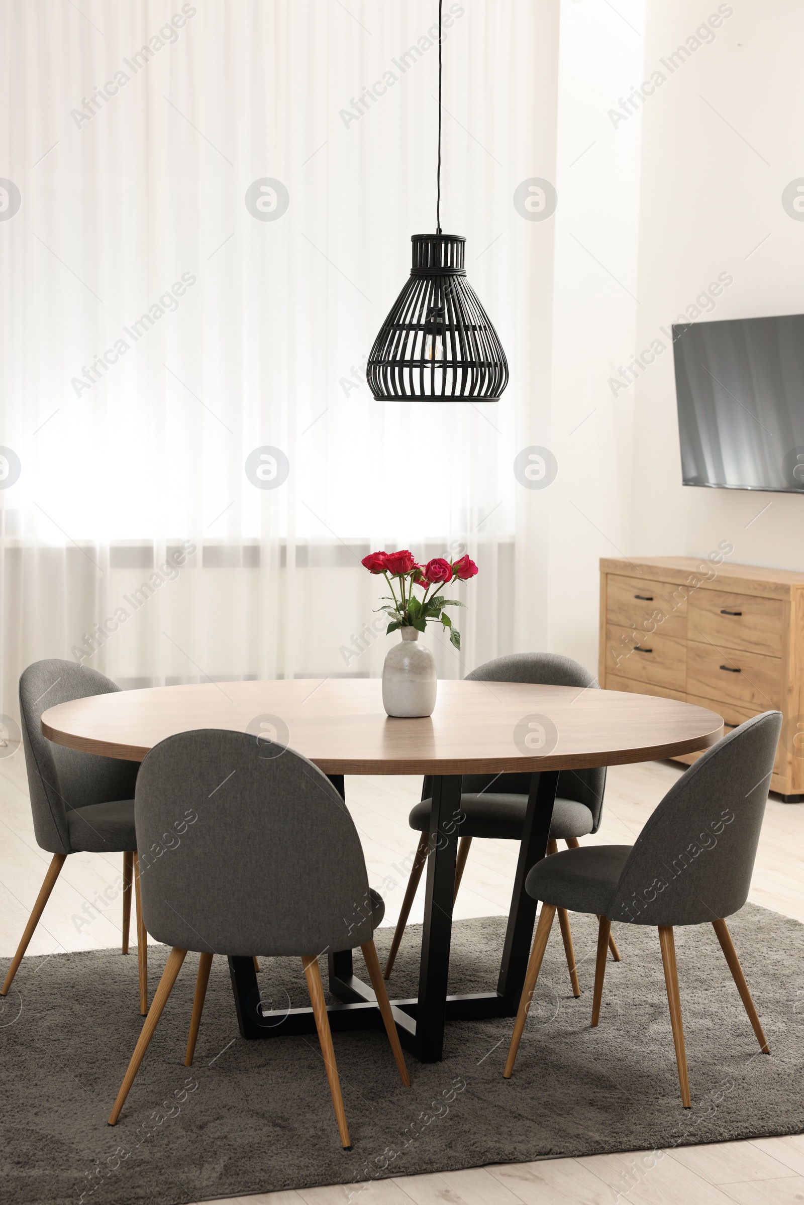 Photo of Stylish dining room interior with table and chairs