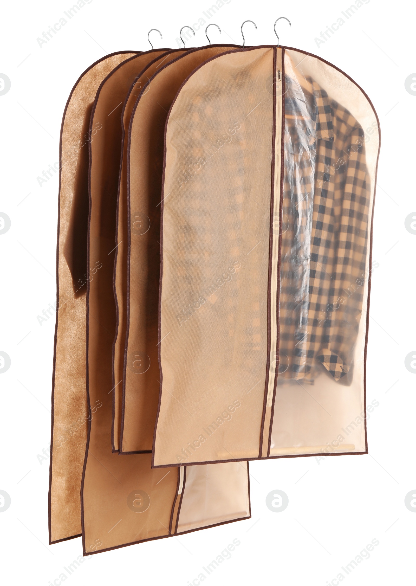 Photo of Garment bags with clothes on white background