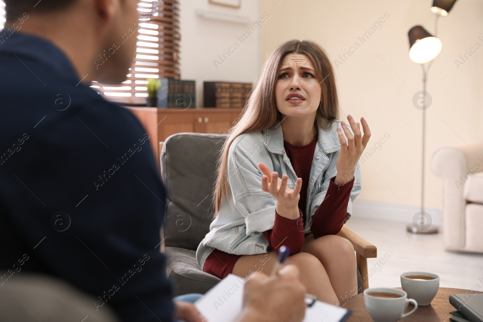 Photo of Professional psychotherapist working with patient in office