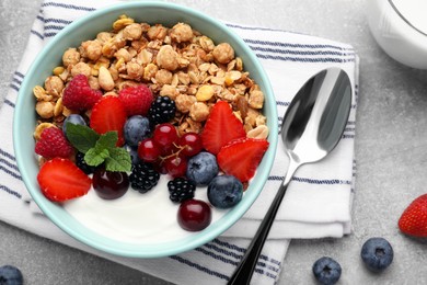 Photo of Flat lay composition with tasty granola and berries on light grey table. Healthy meal