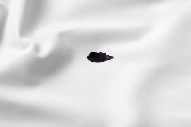 Stain of black ink on white shirt, closeup