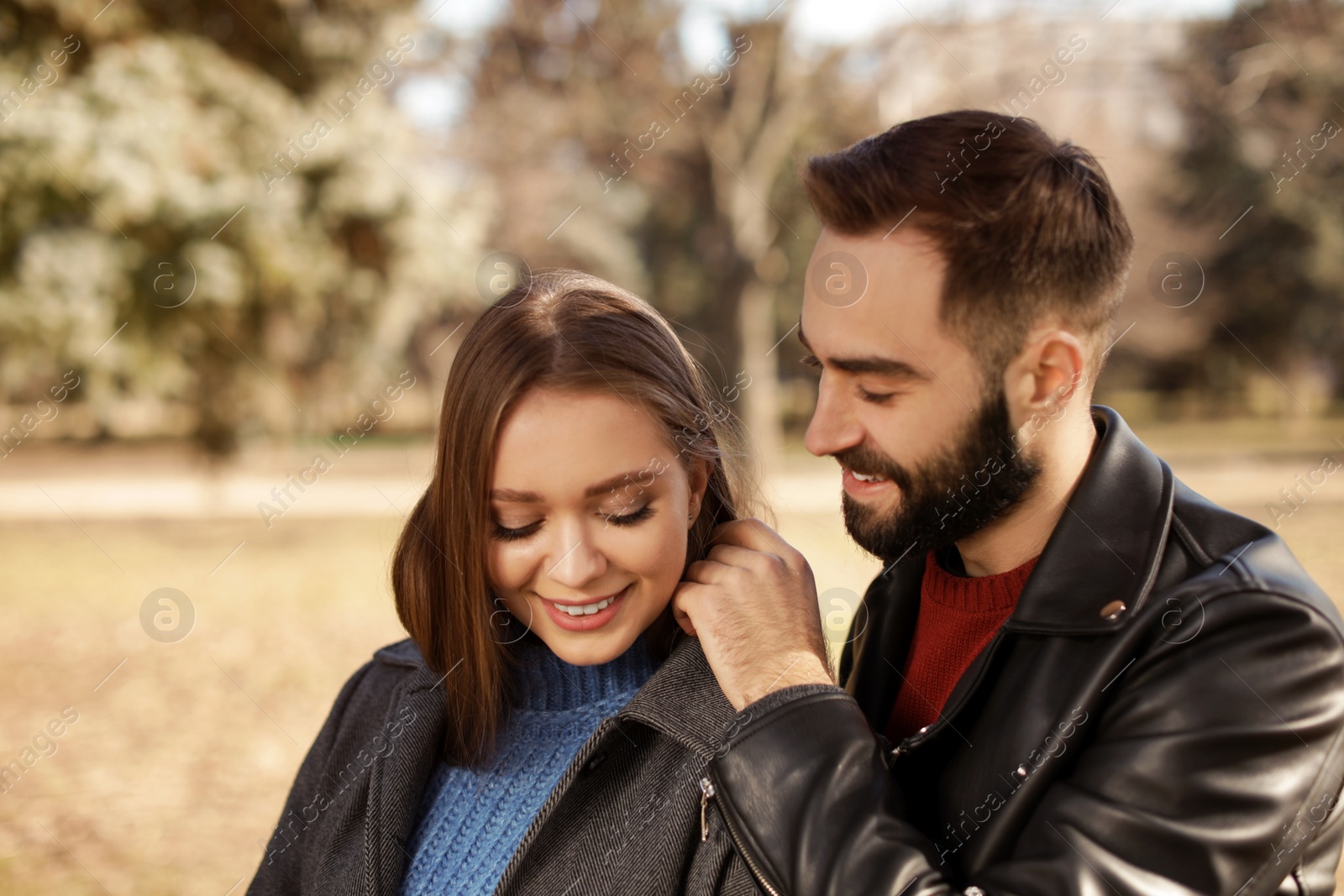 Photo of Portrait of cute young couple in park on sunny day