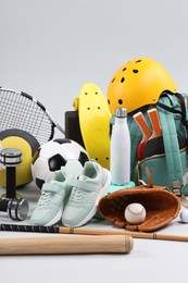 Many different sports equipment on light grey background