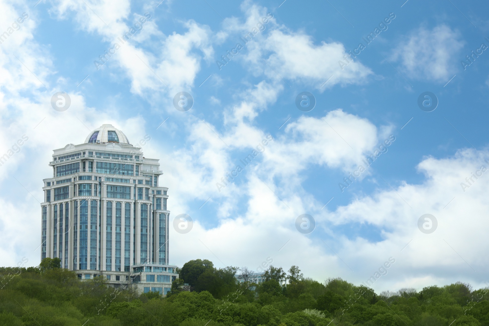 Photo of View of modern city building against sky. Space for text