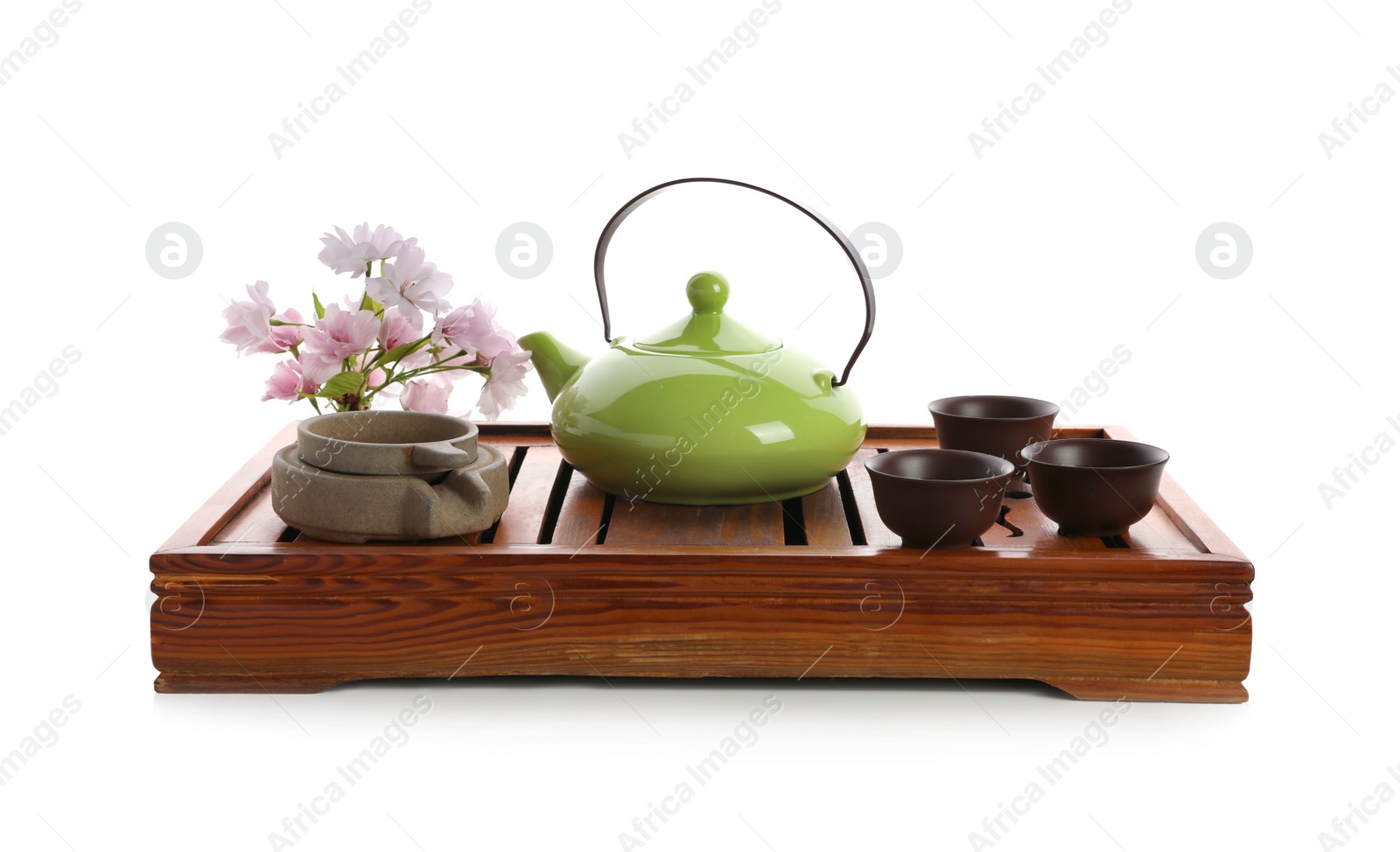 Photo of Beautiful set for traditional tea ceremony and sakura flowers on white background