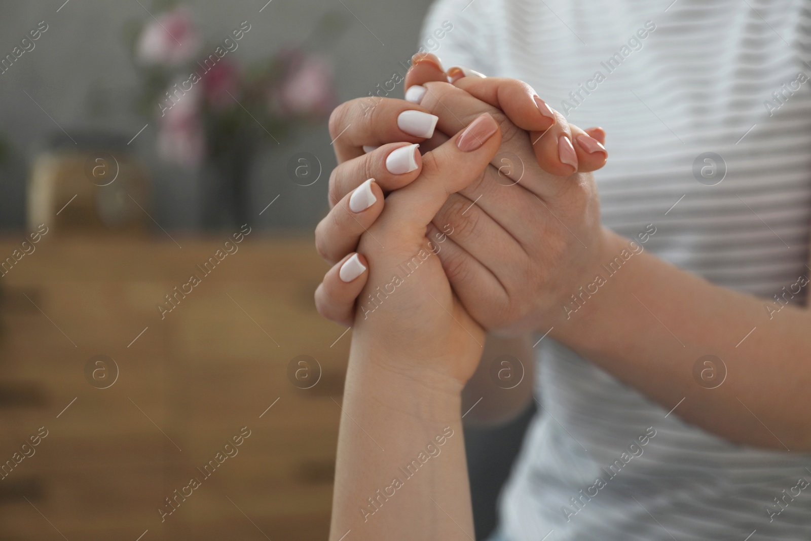 Photo of Doula taking care of pregnant woman indoors, closeup. Preparation for child birth