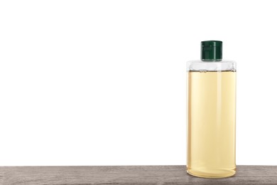 Micellar water in bottle on wooden table against white background. Space for text