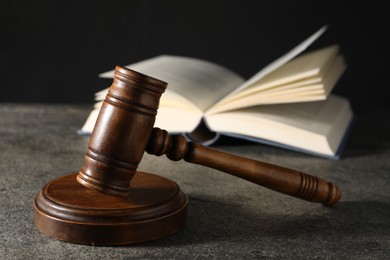 Photo of Law concept. Gavel and book on grey textured table, closeup