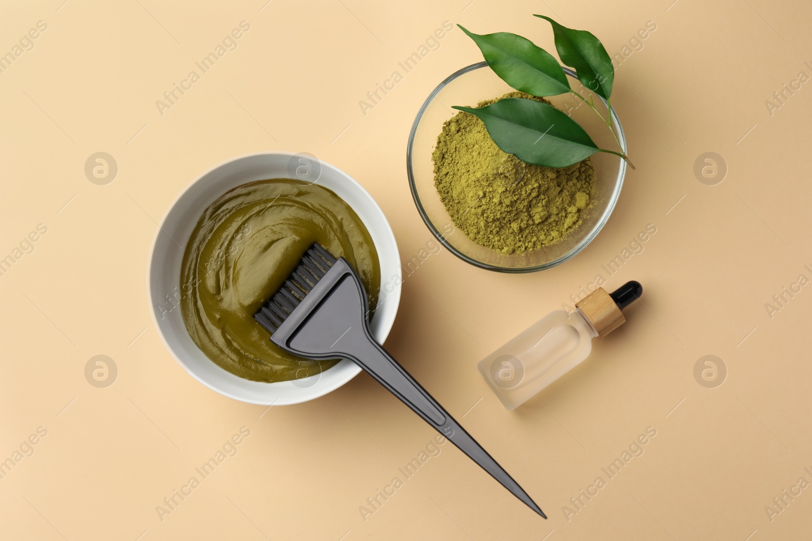 Photo of Henna powder and cream, bottle of liquid on beige background, flat lay. Natural hair coloring