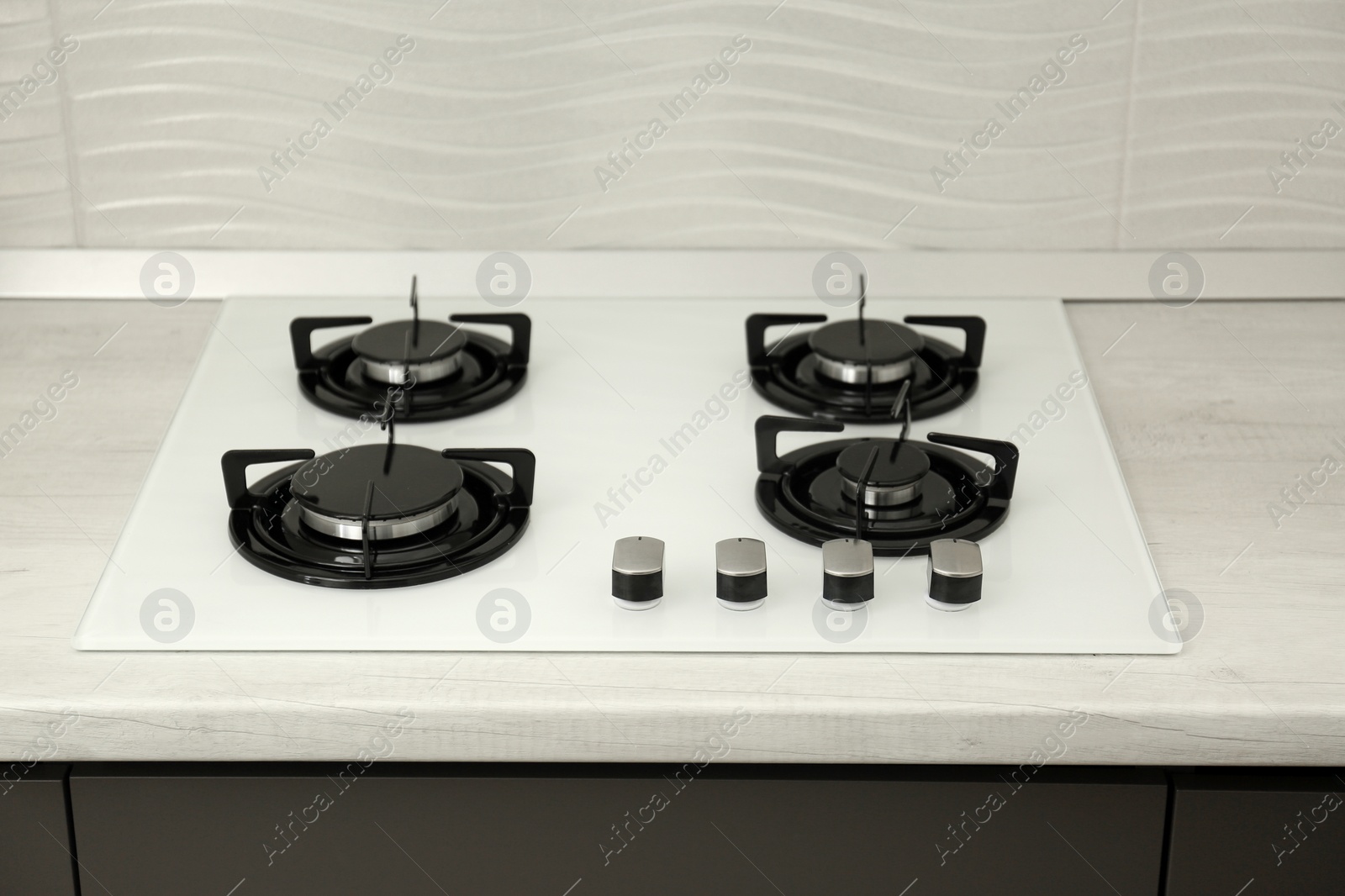 Photo of Modern built-in gas cooktop. Kitchen appliance