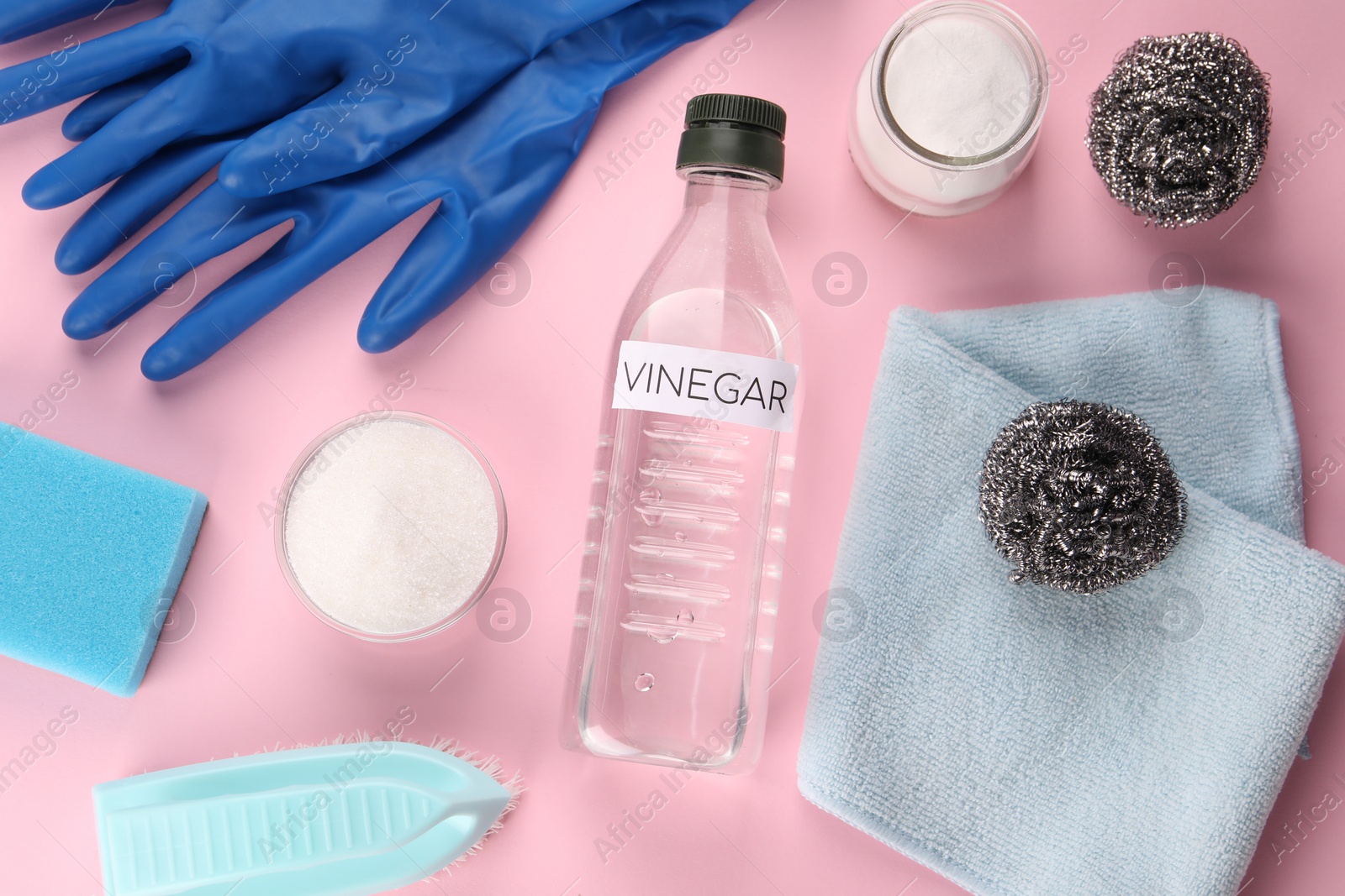 Photo of Eco friendly natural cleaners. Flat lay composition with bottle of vinegar on pink background