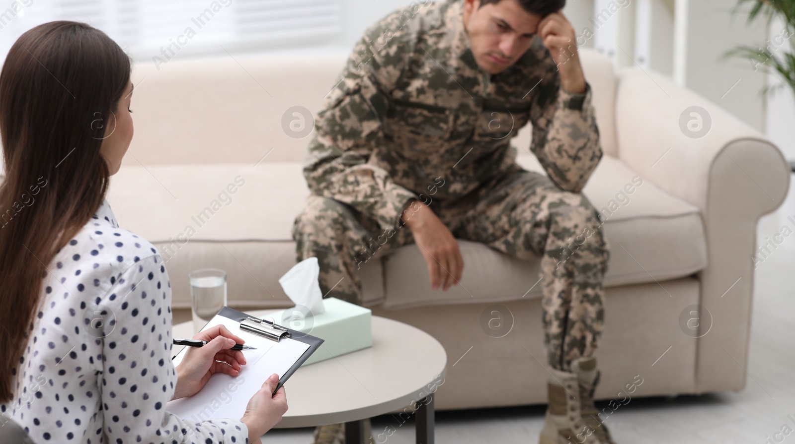 Photo of Psychotherapist working with male military officer in office