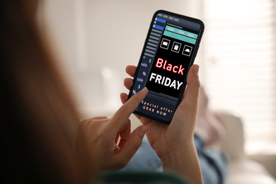 Image of Black Friday. Woman shopping online using smartphone, closeup