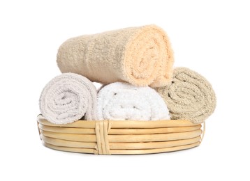 Wicker basket with rolled bath towels isolated on white