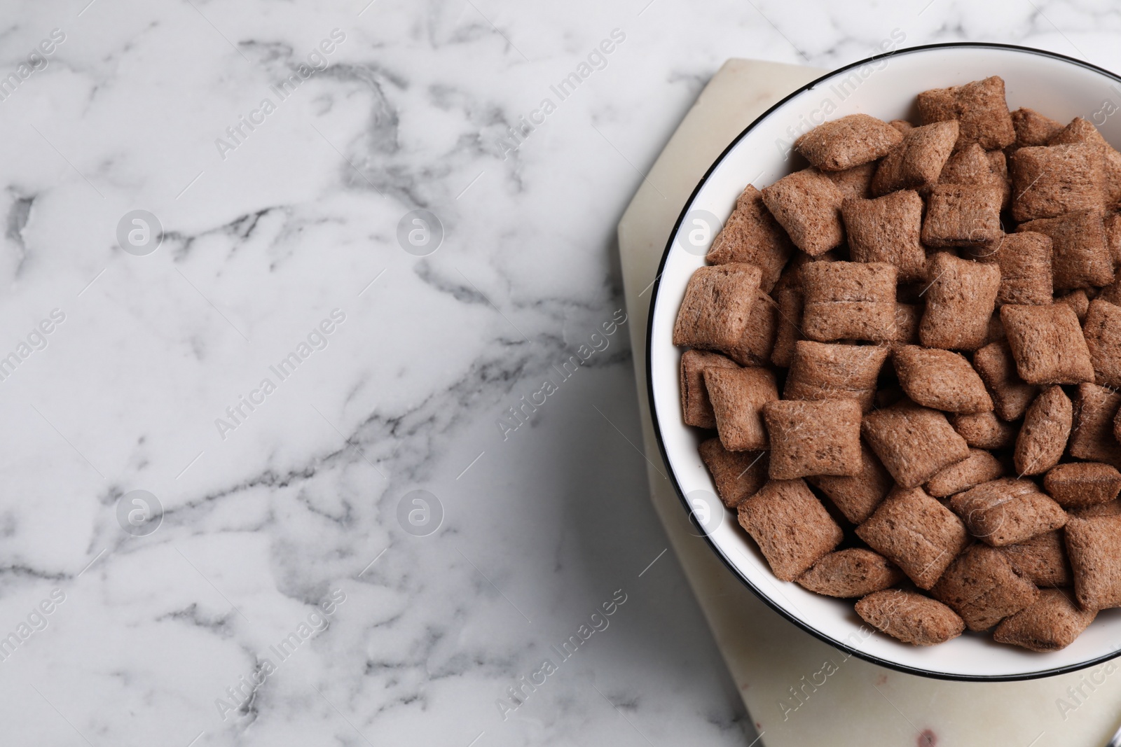 Photo of Delicious chocolate corn pads on white marble table, top view. Space for text