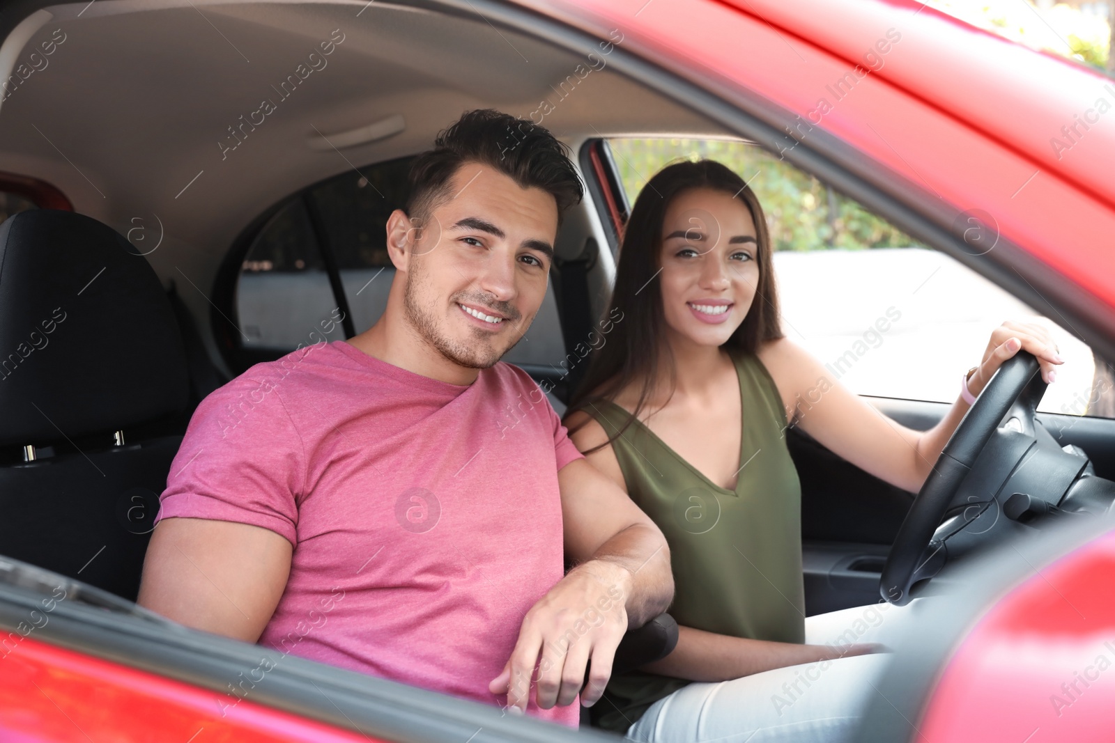 Photo of Happy young couple in car on road trip