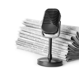 Newspapers and vintage microphone isolated on white. Journalist's work