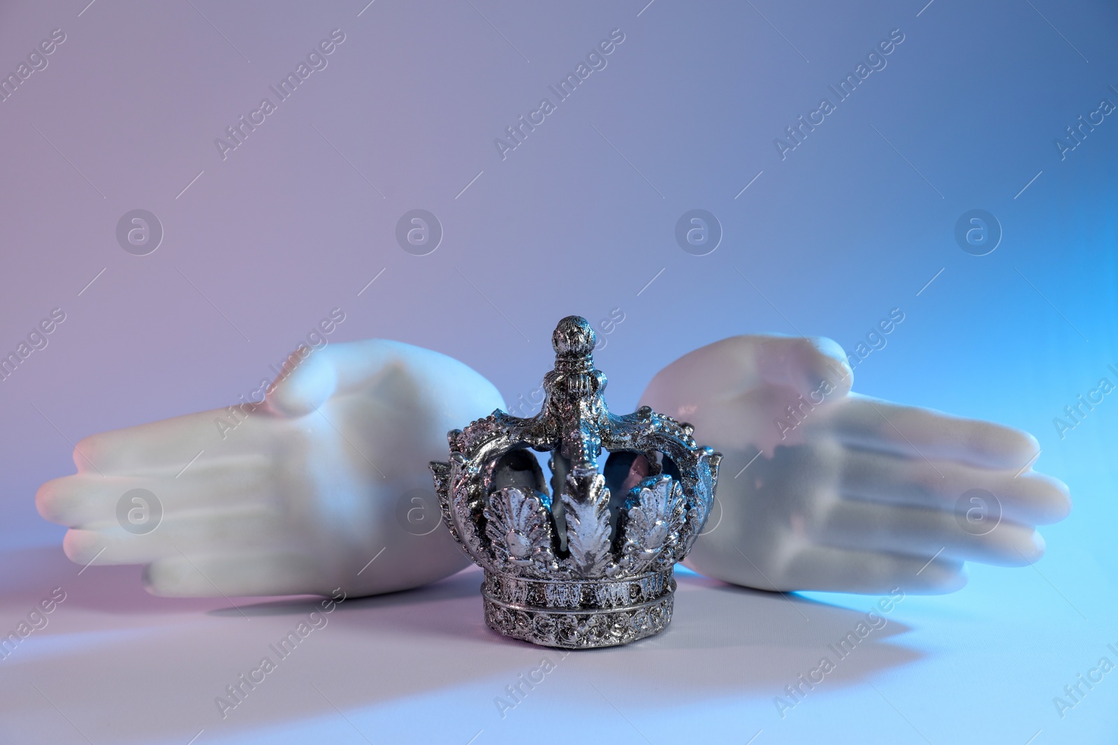 Photo of Beautiful silver crown and other decor elements on white background, space for text. Color tone effect