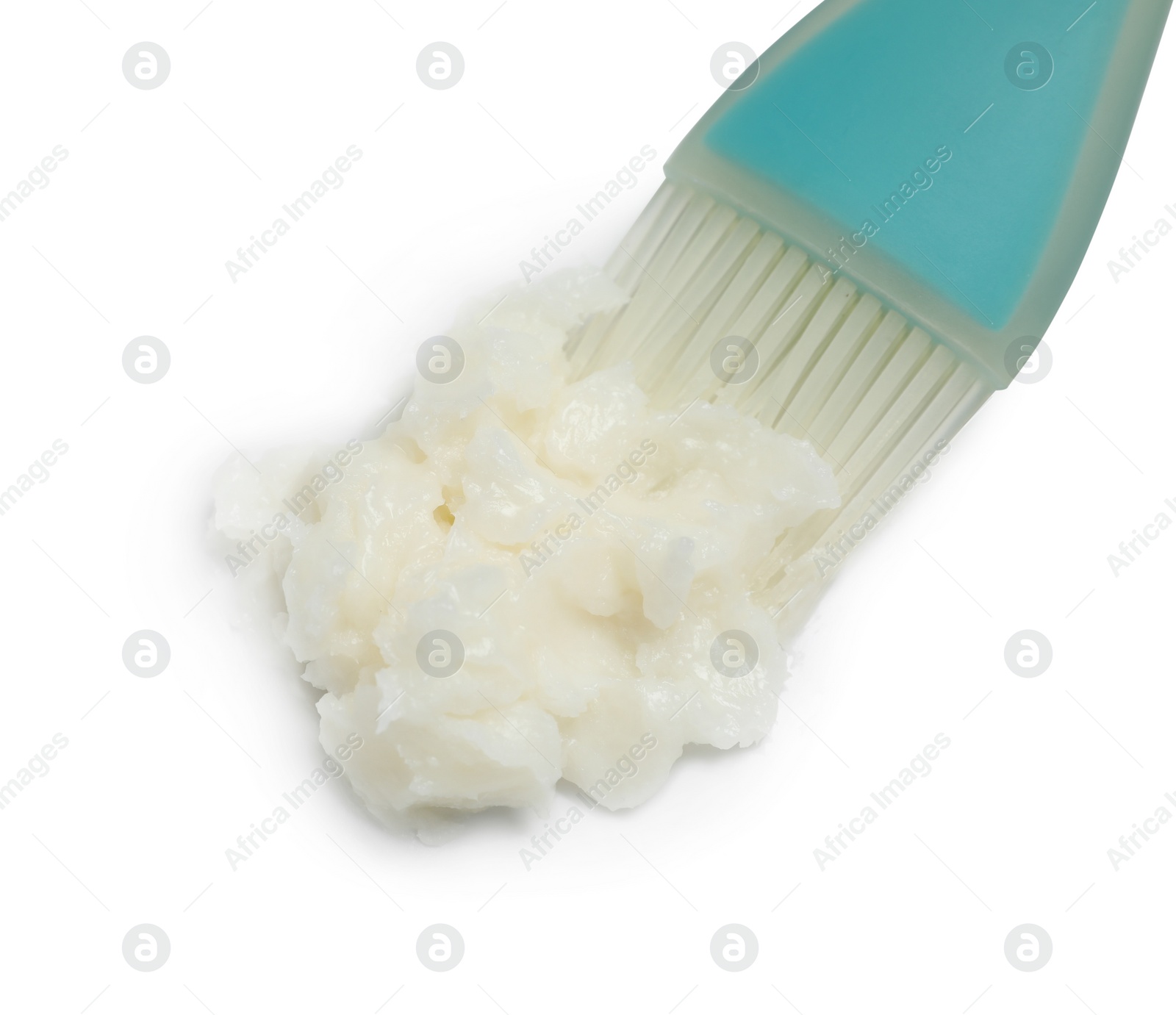 Photo of Baking dish with coconut oil and silicone brush on white background, closeup