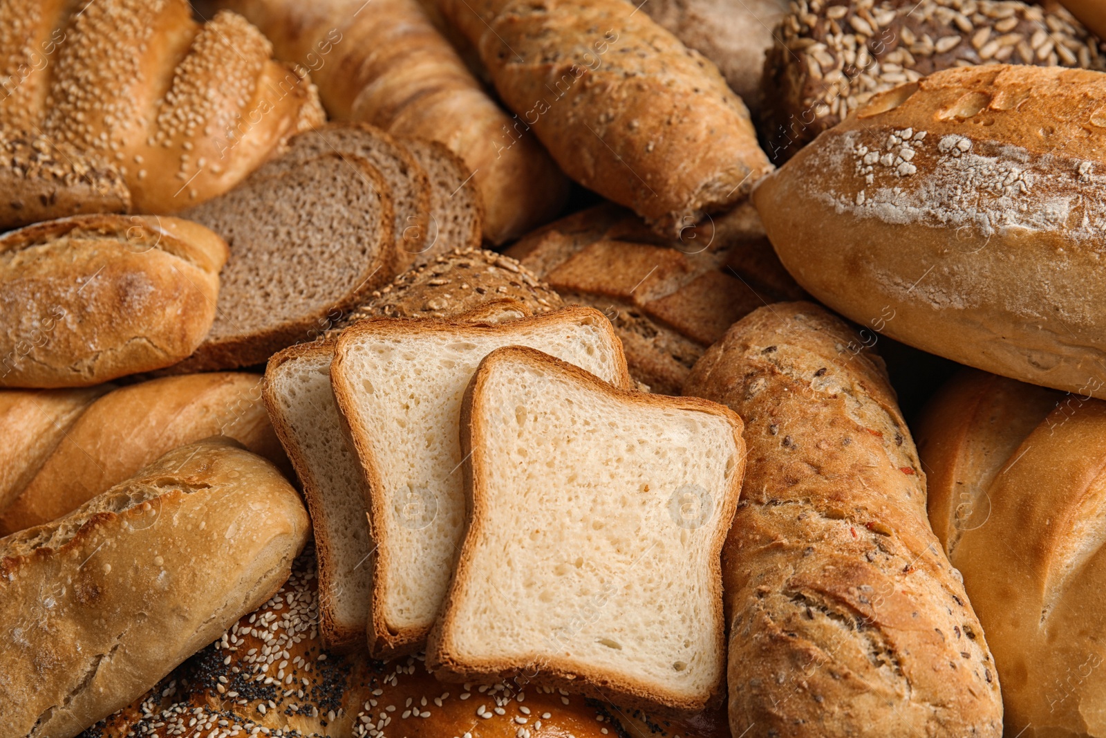 Photo of Different kinds of fresh bread as background, closeup