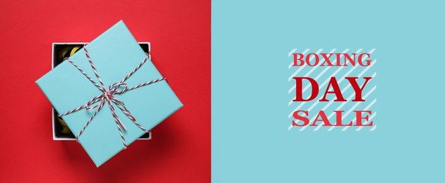 Boxing day sale. Top view of gift on red background, banner design