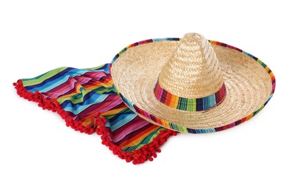 Photo of Mexican sombrero hat and colorful poncho isolated on white