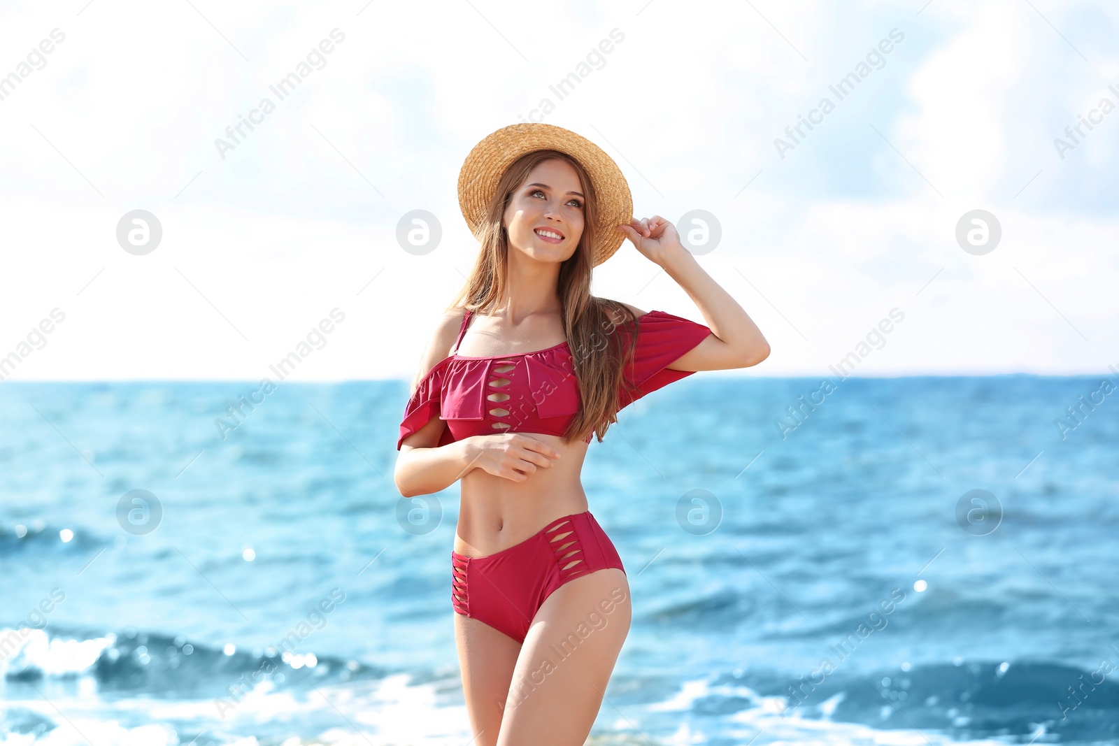 Photo of Attractive young woman in beautiful bikini swimsuit on beach