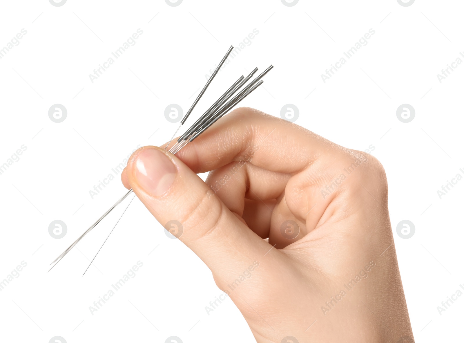 Photo of Woman holding needles for acupuncture on white background, closeup