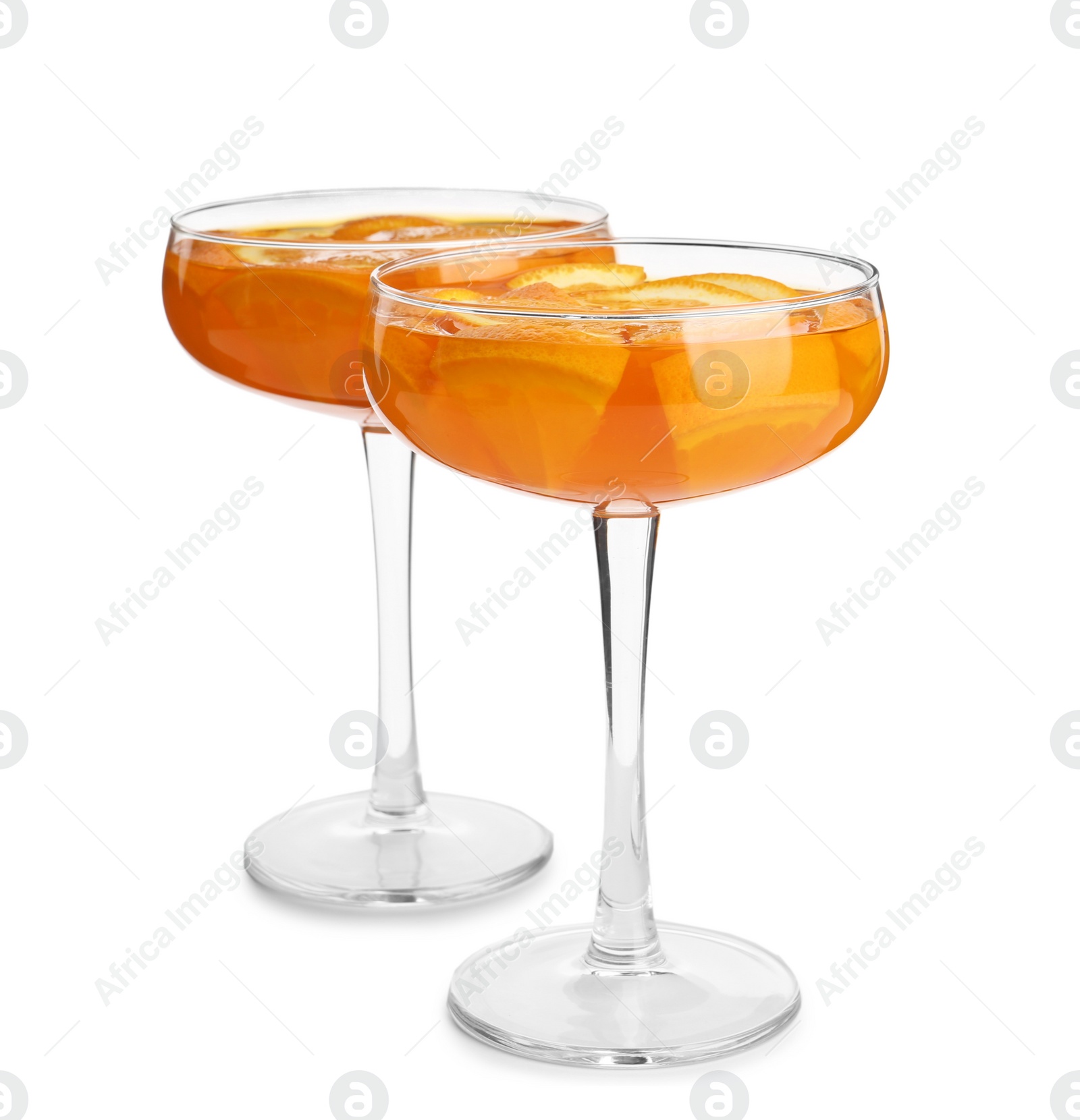 Photo of Tasty jelly desserts with slices of orange in glasses on white background