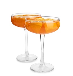 Photo of Tasty jelly desserts with slices of orange in glasses on white background