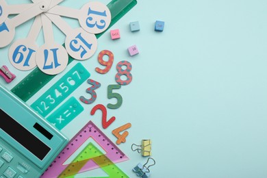Photo of Flat lay composition with colorful numbers and rulers on light background. Space for text