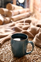 Photo of Wicker mat with freshly brewed tea in room. Cozy home atmosphere