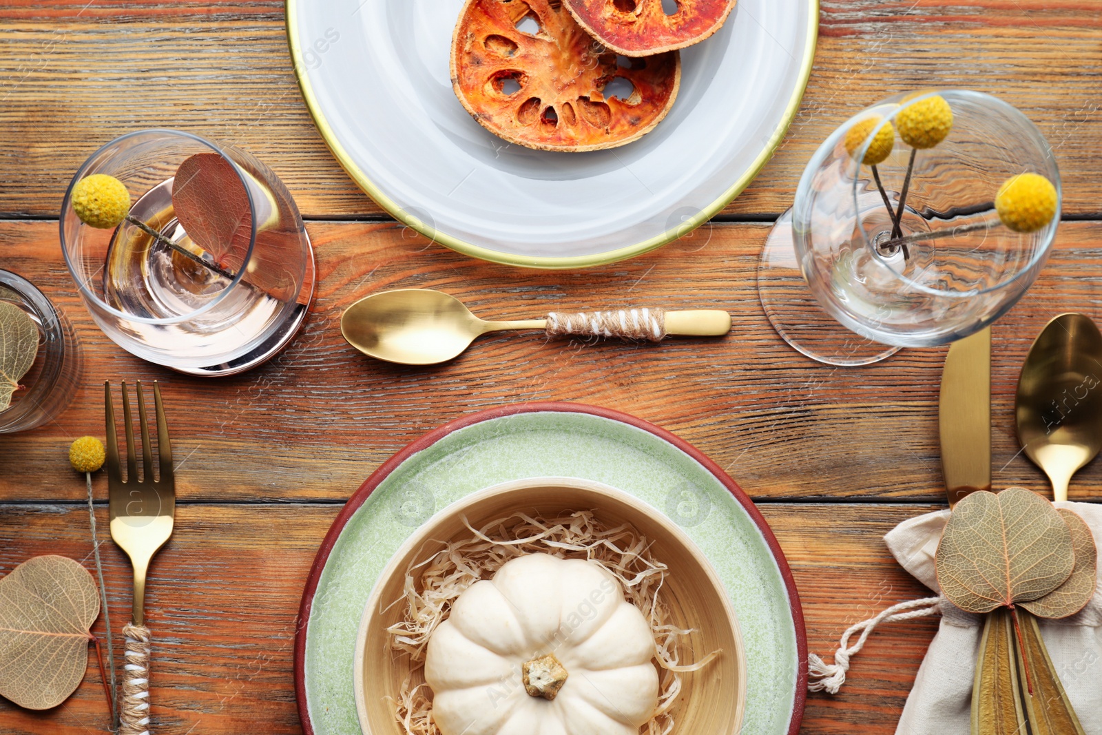 Photo of Autumn table setting with pumpkin and decor on wooden background, flat lay