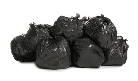 Photo of Black trash bags filled with garbage on white background