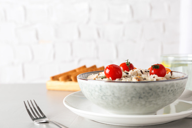 Delicious rice in bowl served on grey table. Space for text