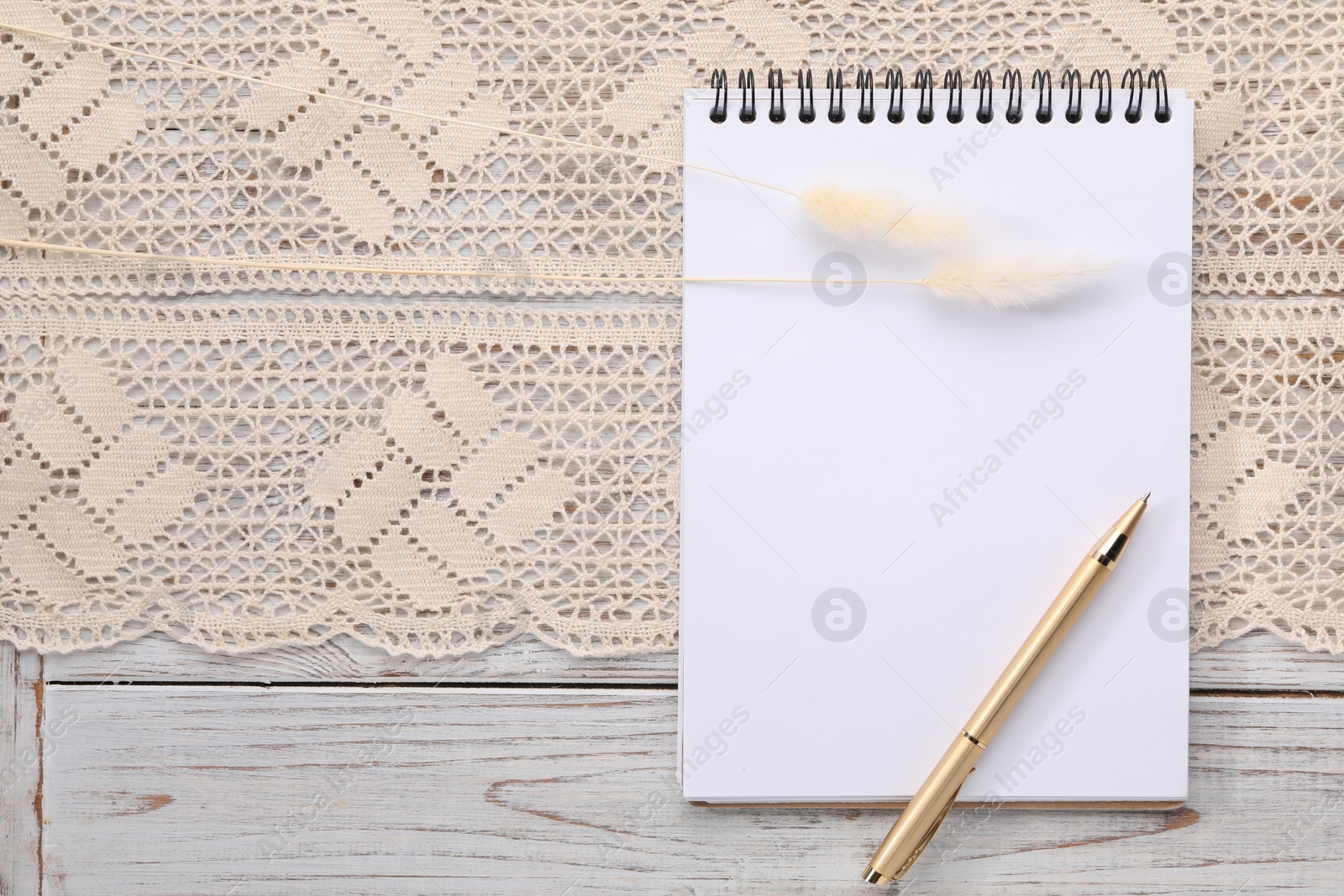 Photo of Guest list. Notebook, pen, spikelets and lace ribbon on wooden background, flat lay. Space for text