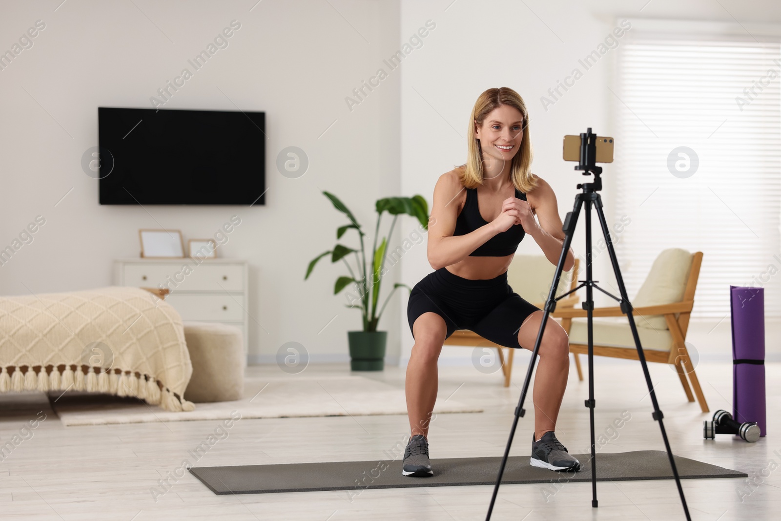 Photo of Fitness trainer recording online classes at home