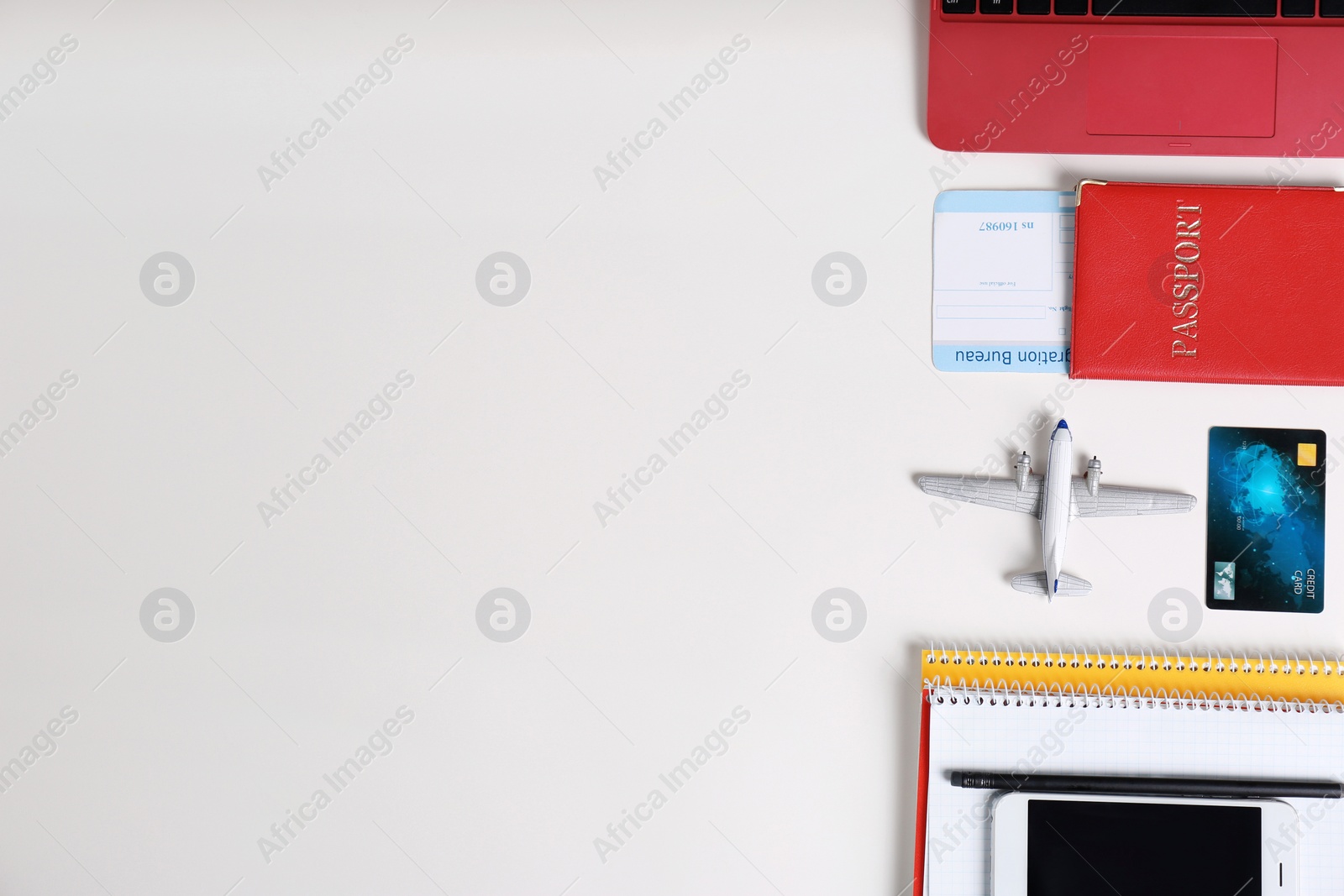 Photo of Flat lay composition with passport and plane model on white background, space for text. Travel agency