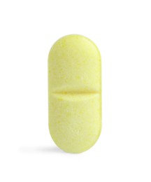 Photo of One yellow pill isolated on white. Medicinal treatment