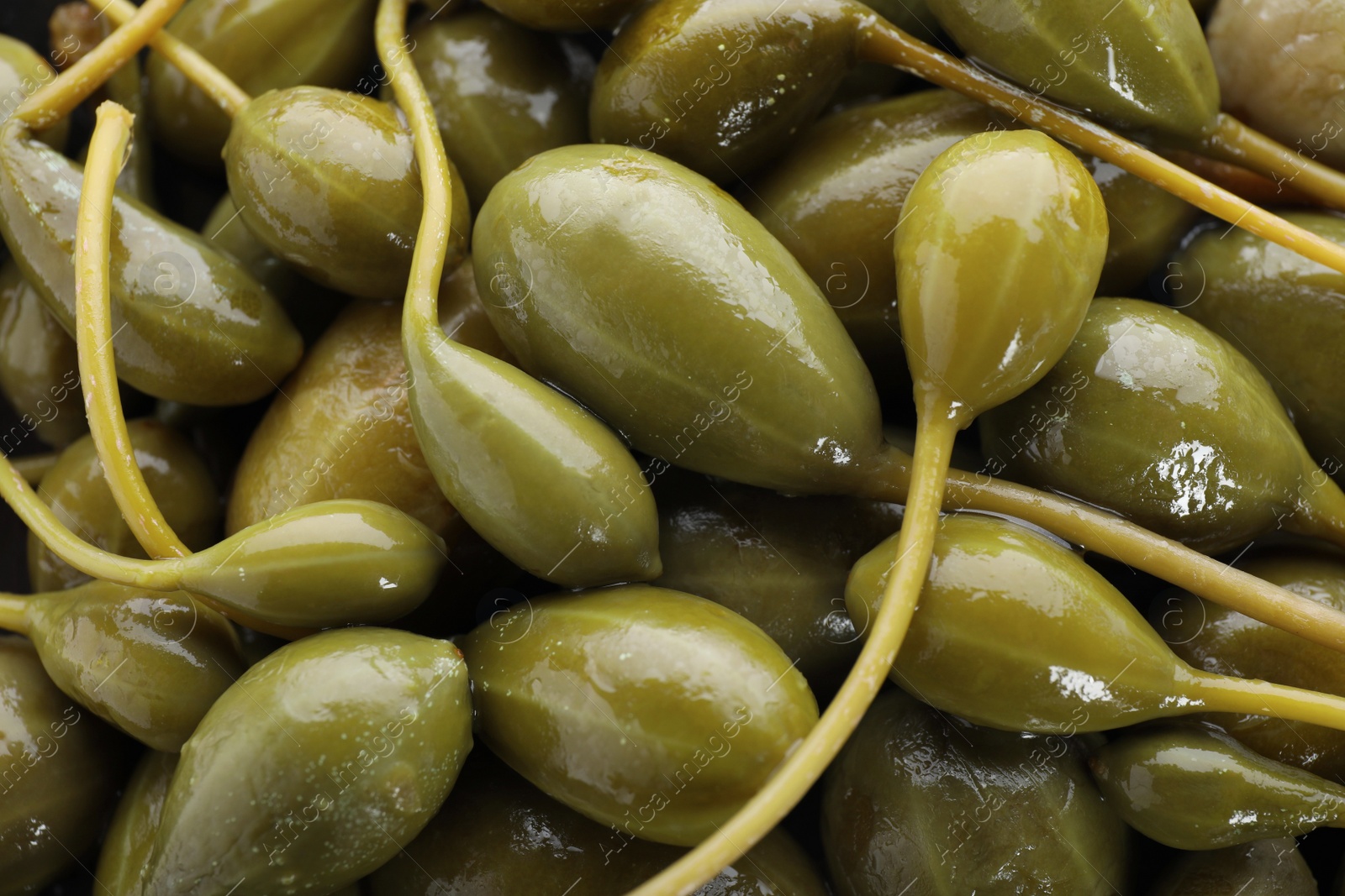 Photo of Closeup of pickled capers as background, top view