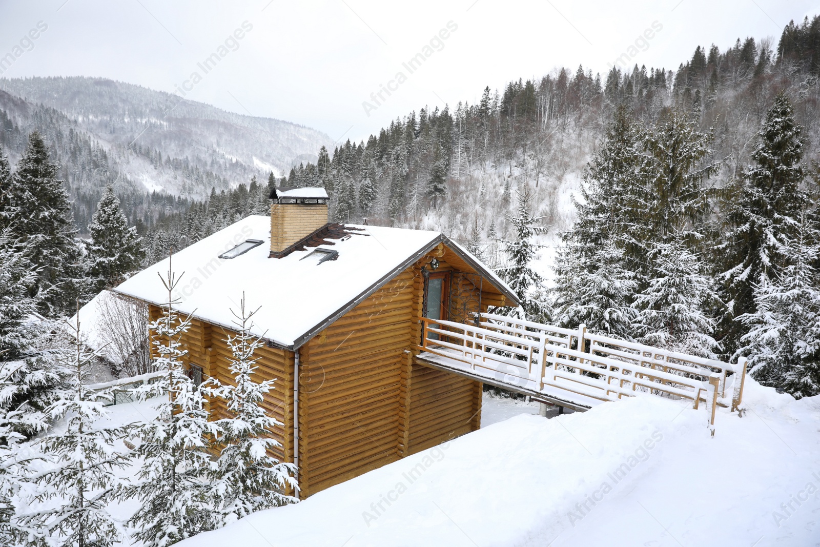 Photo of Beautiful landscape with cottage on snowy winter day