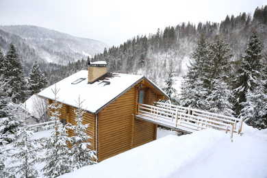 Beautiful landscape with cottage on snowy winter day