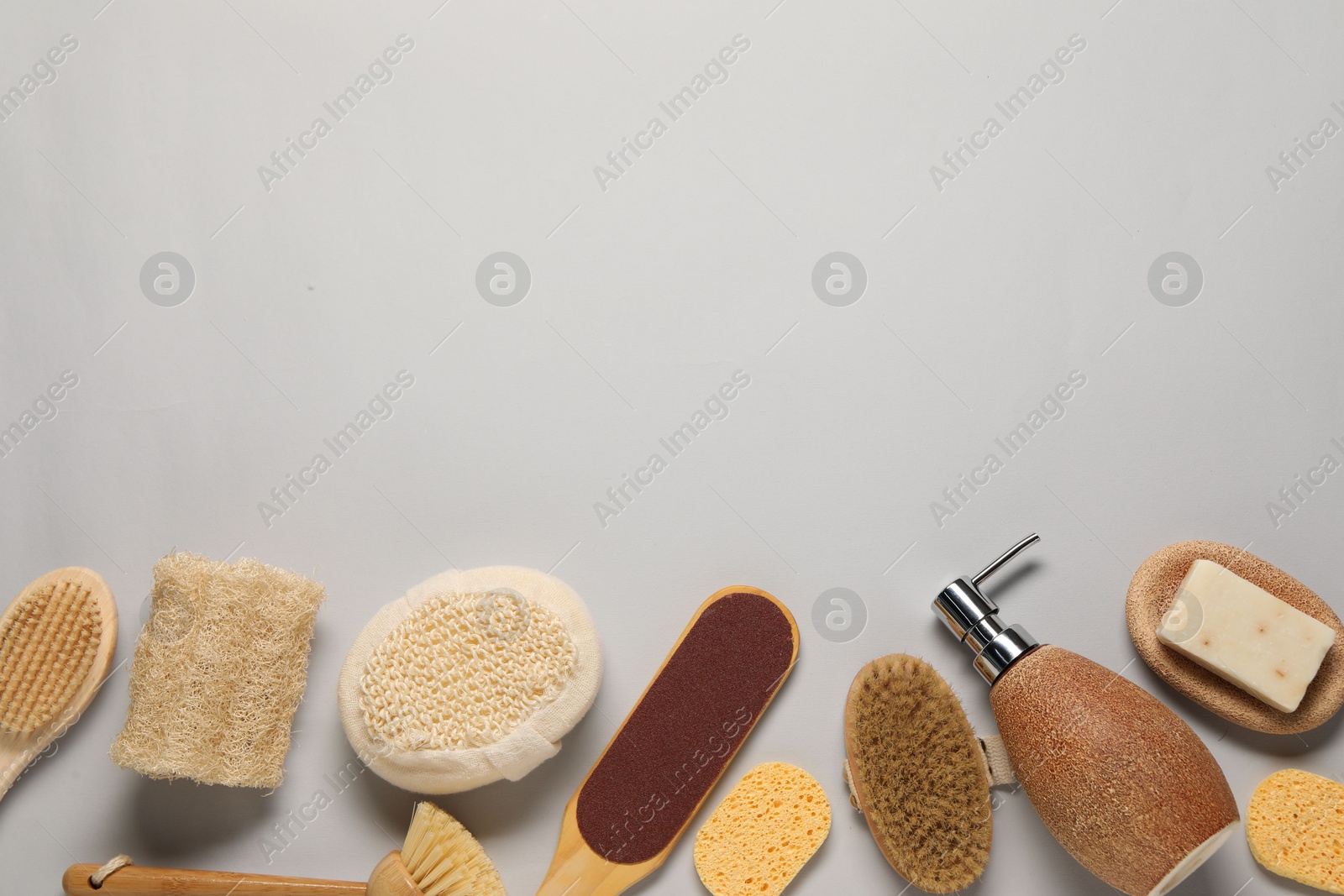 Photo of Bath accessories. Flat lay composition with personal care tools on light grey background, space for text