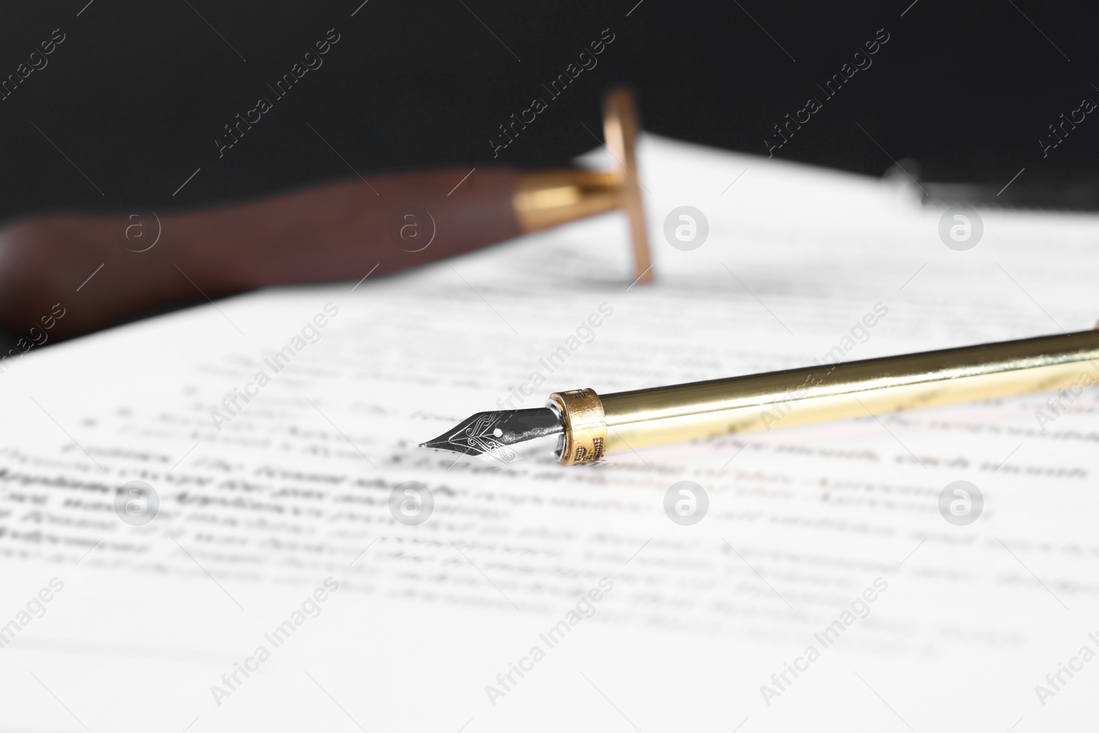 Photo of Fountain pen and paper document on table, closeup with space for text. Notary service