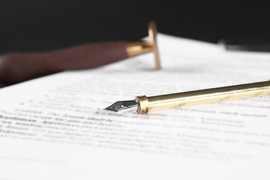 Photo of Fountain pen and paper document on table, closeup with space for text. Notary service