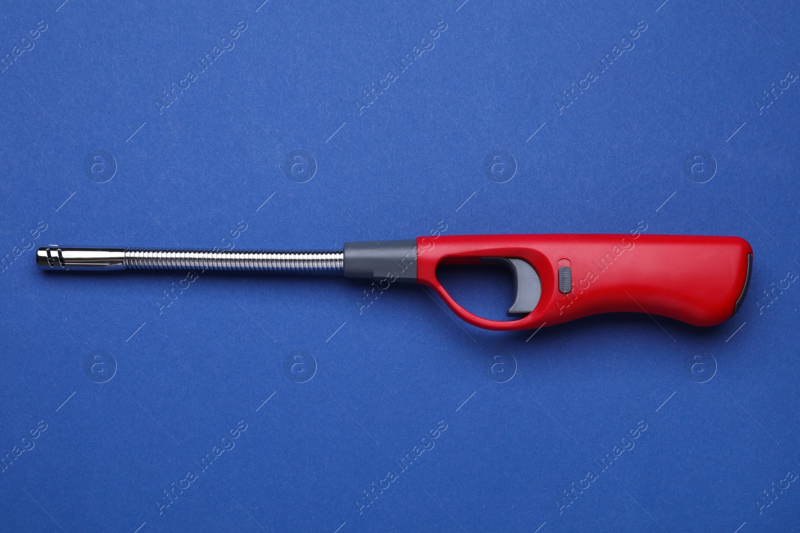 Photo of One gas lighter on blue background, top view