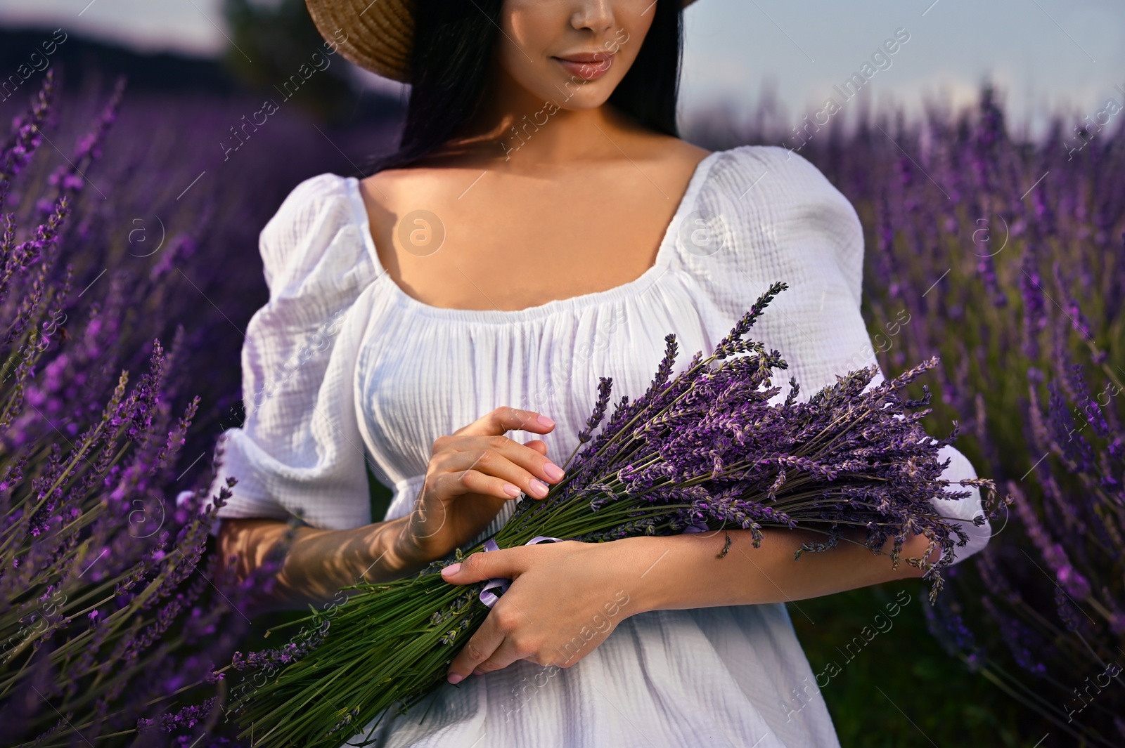 Photo of Woman with bouquet in lavender field, closeup