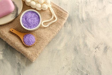 Beautiful composition with purple sea salt on stone table, top view. Space for text