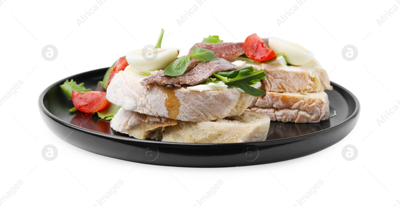 Photo of Delicious bruschettas with anchovies, cream cheese, eggs and tomatoes isolated on white